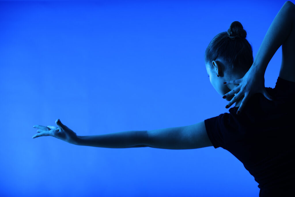 woman dancing on a blue background